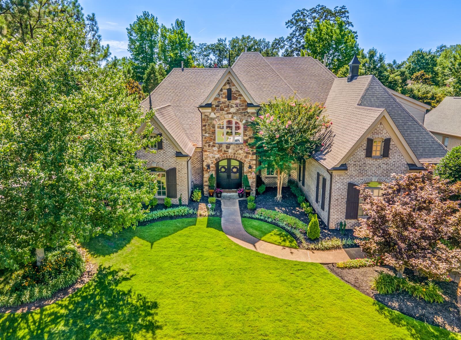 a front view of house with yard and green space