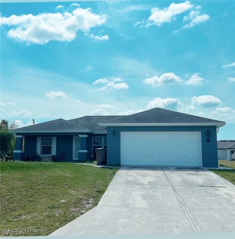 a front view of a house with a garden and yard