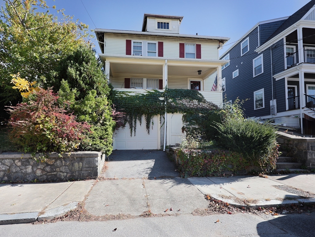 a front view of a house with a garden