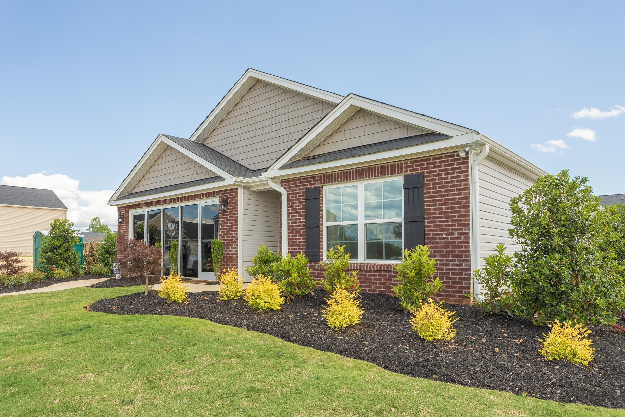 a view of a house with backyard and sitting area