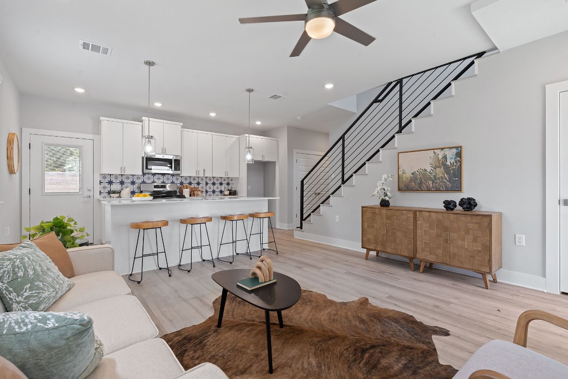 a living room with furniture and kitchen view