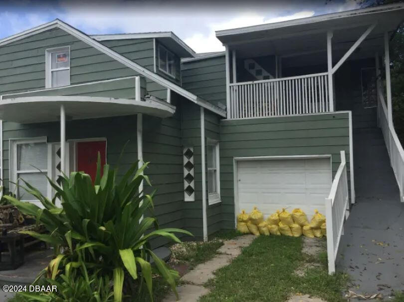 a house with a yard and potted plants