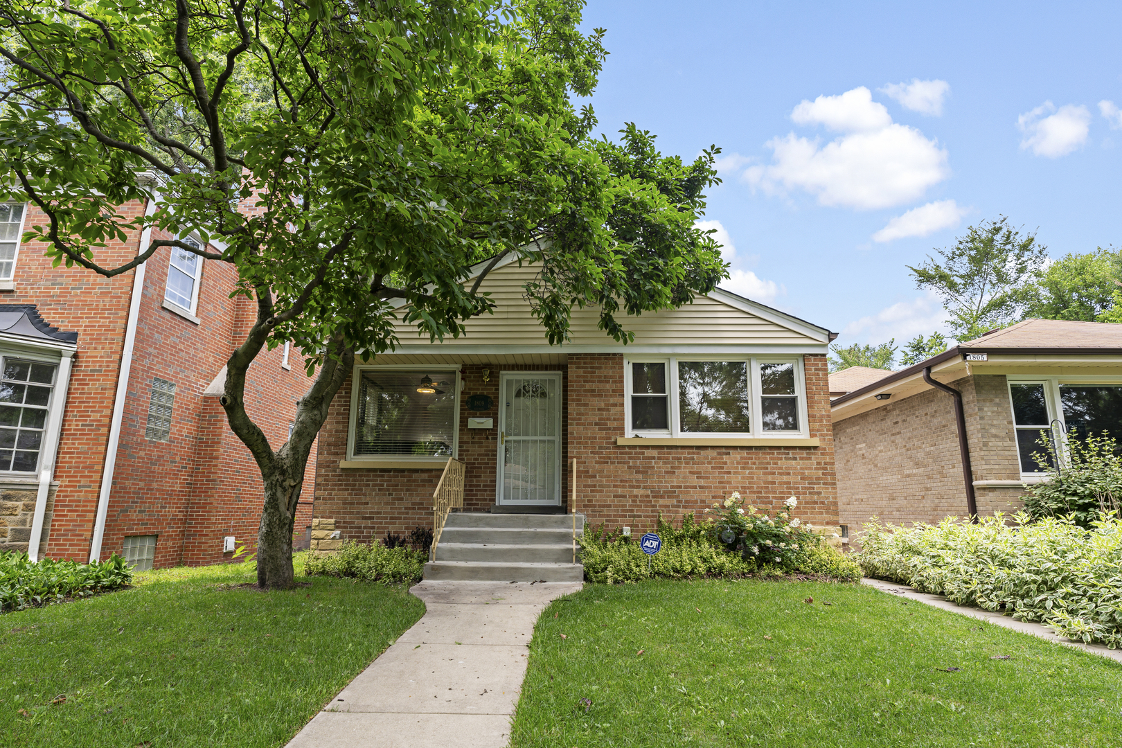 a front view of a house with a garden