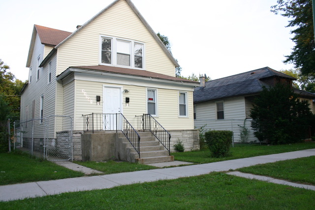 a view of backyard of house with green space