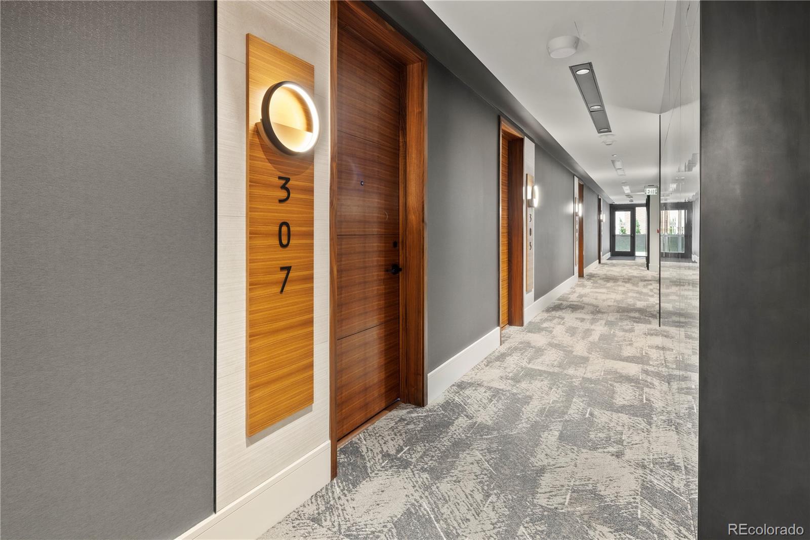 a view of a hallway with wooden door