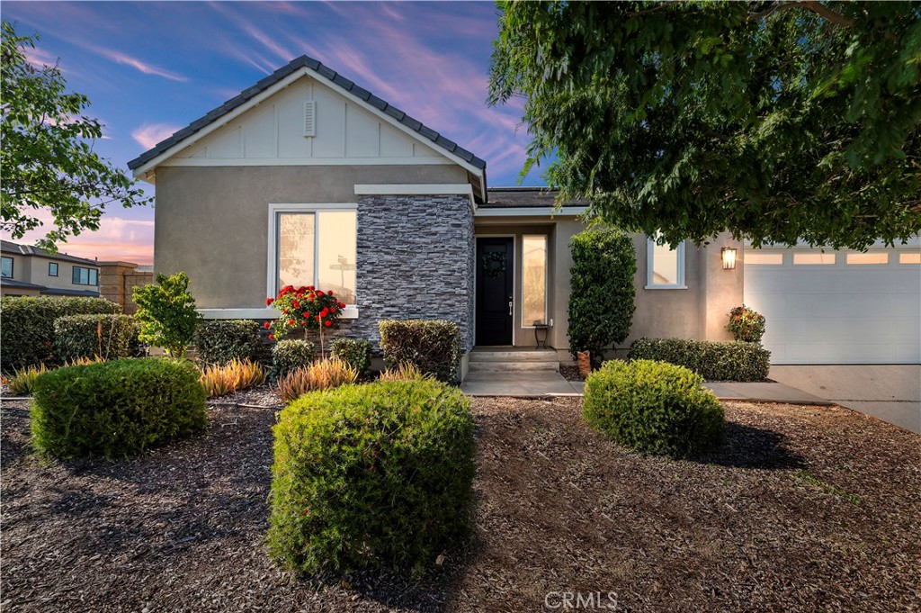 a front view of a house with garden