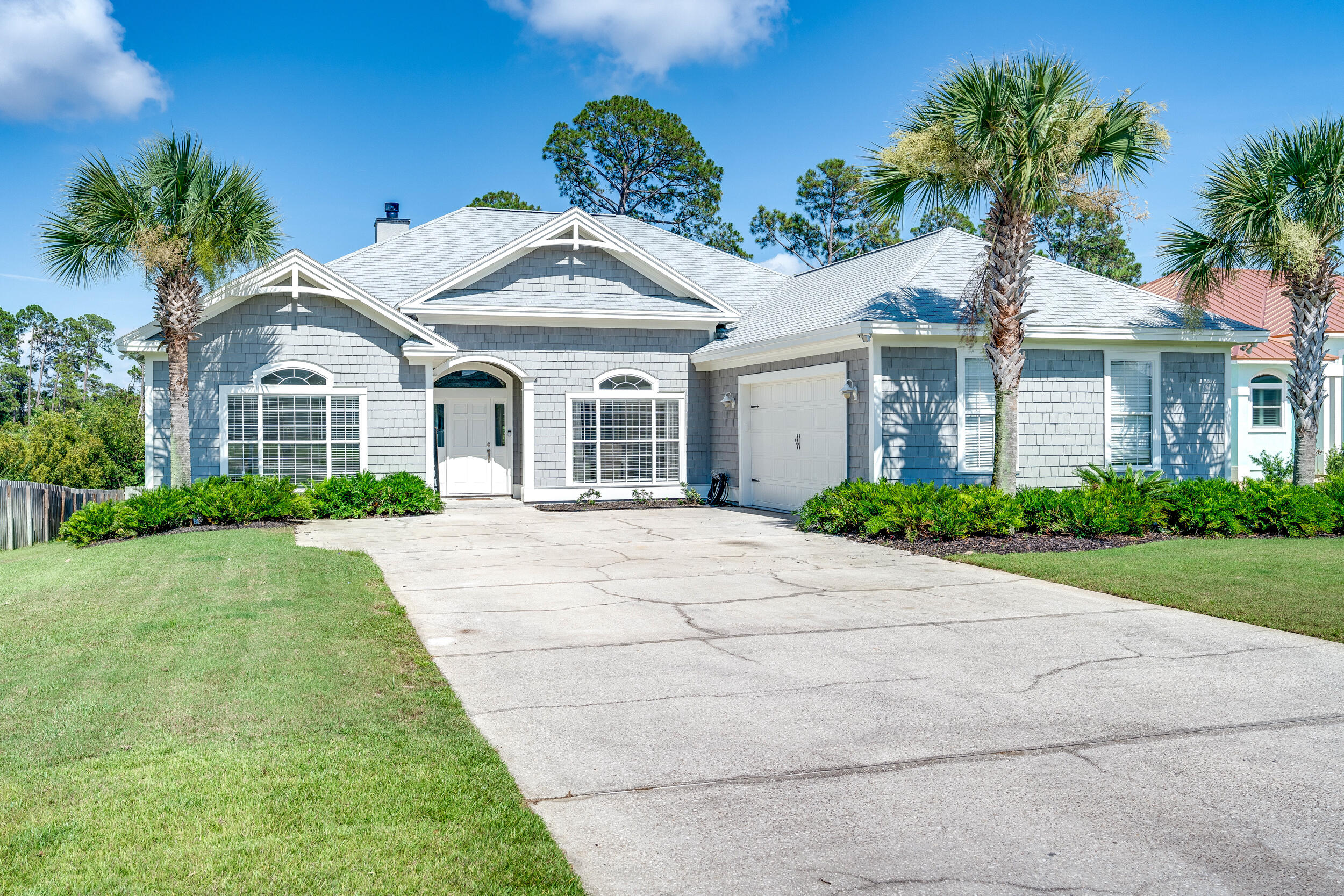 a front view of a house with a garden