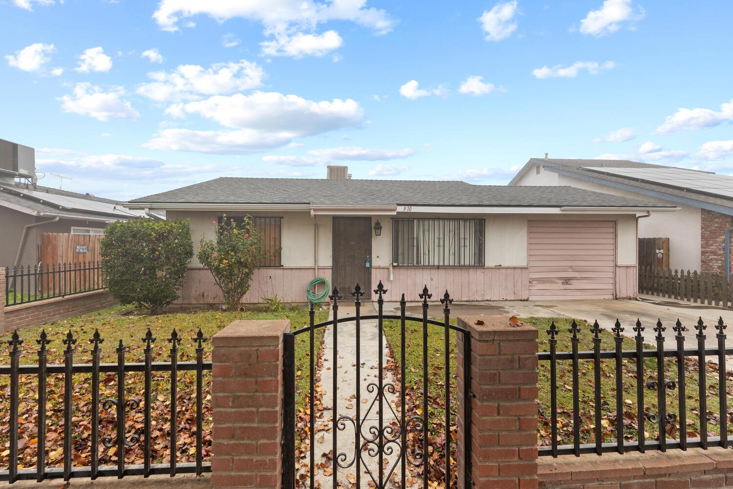 a view of a house with a wooden fence