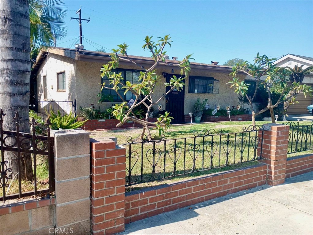 a view of a house with wooden fence