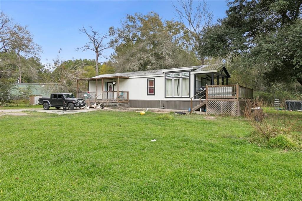 a front view of house with yard and trees