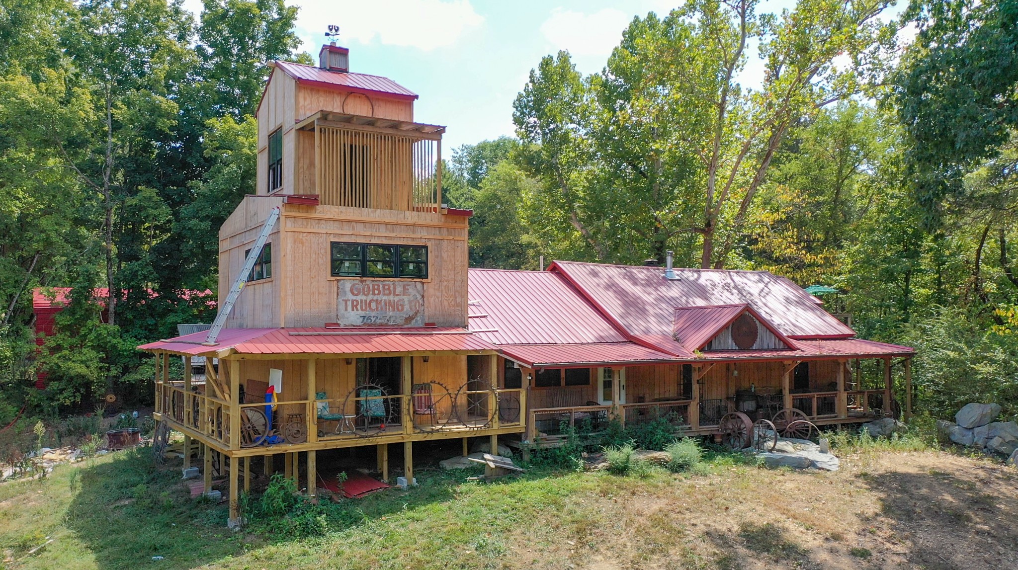 a view of a house with a yard balcony and furniture