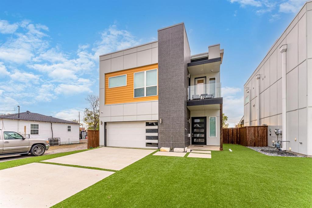 a front view of a house with a garden and parking