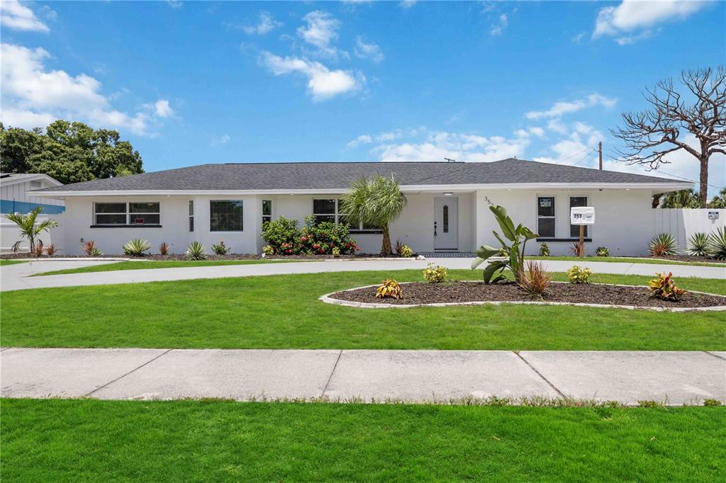 a front view of house with yard and green space