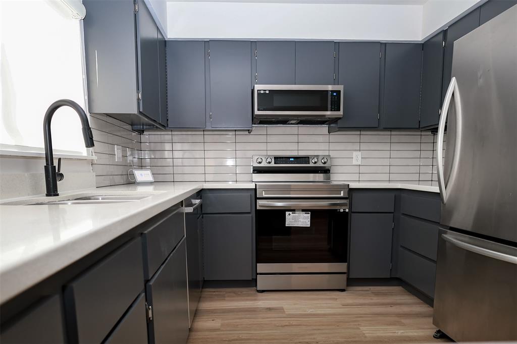 a kitchen with a sink stove and refrigerator