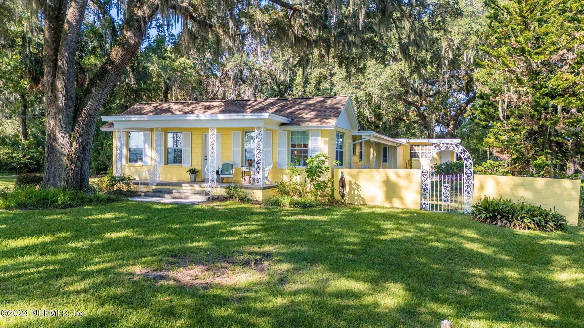 a front view of house with yard and green space