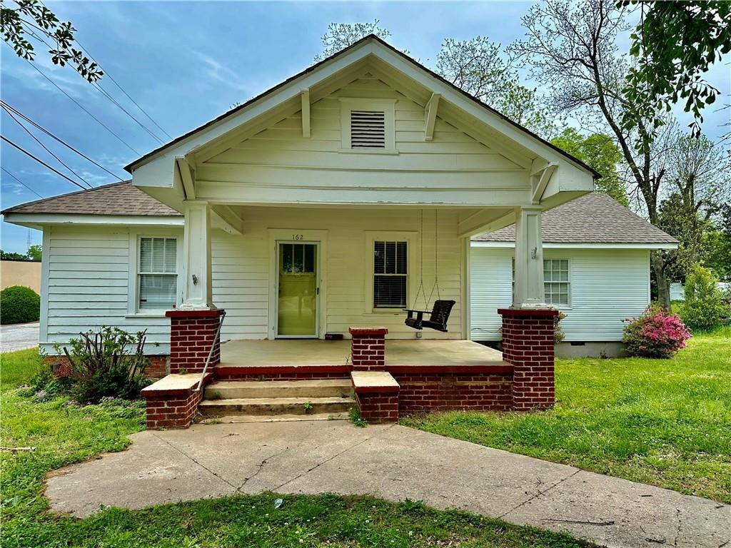 a view of backyard with wooden deck and floor to ceiling window