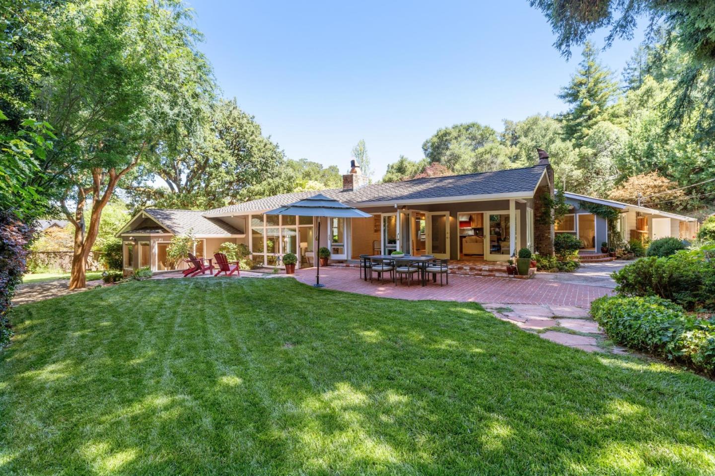 a front view of a house with yard and green space