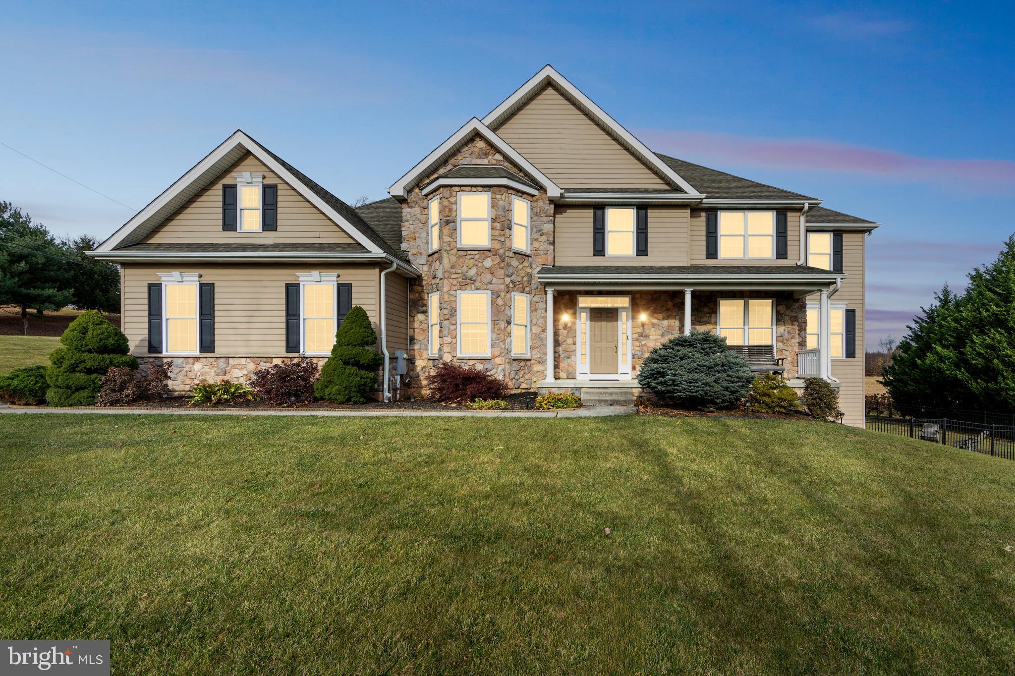 a front view of a house with a yard and porch