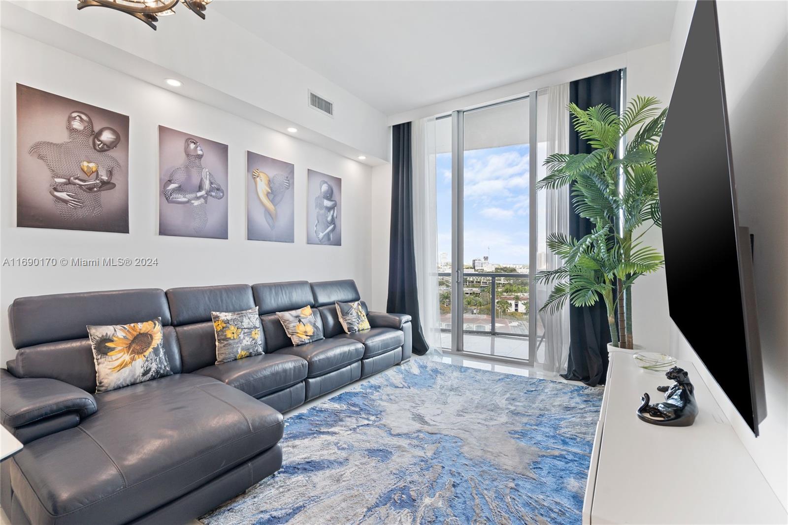 a living room with furniture and a potted plant