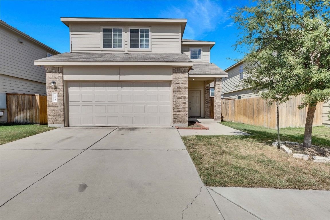 a front view of a house with garage