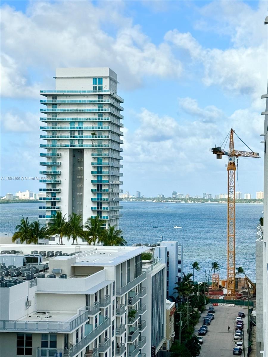 a view of ocean with a city skyline in the background