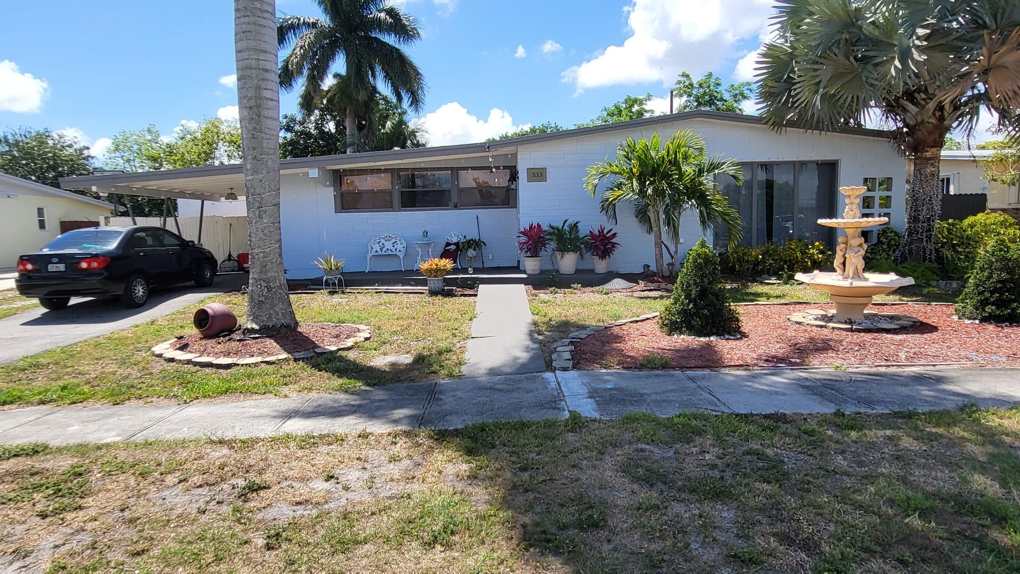 a view of a house with backyard swimming pool and sitting area