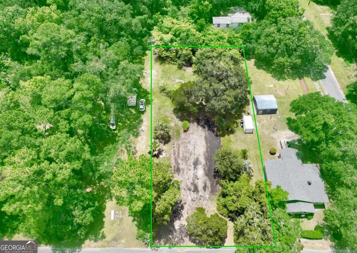 an aerial view of a house with a yard