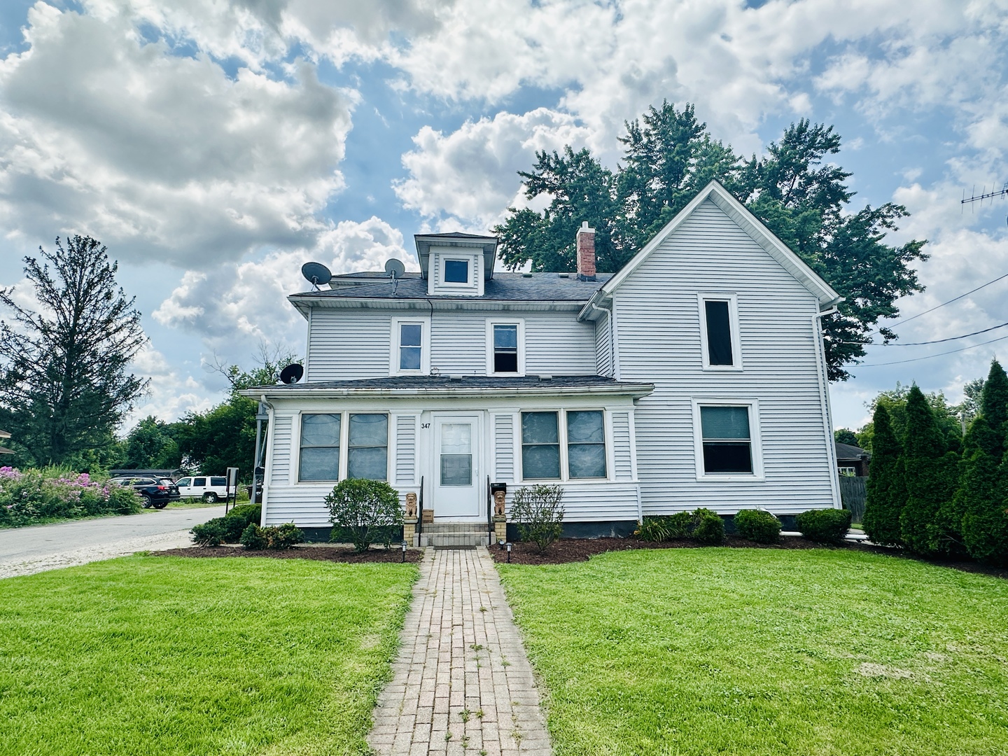 a front view of a house with a garden