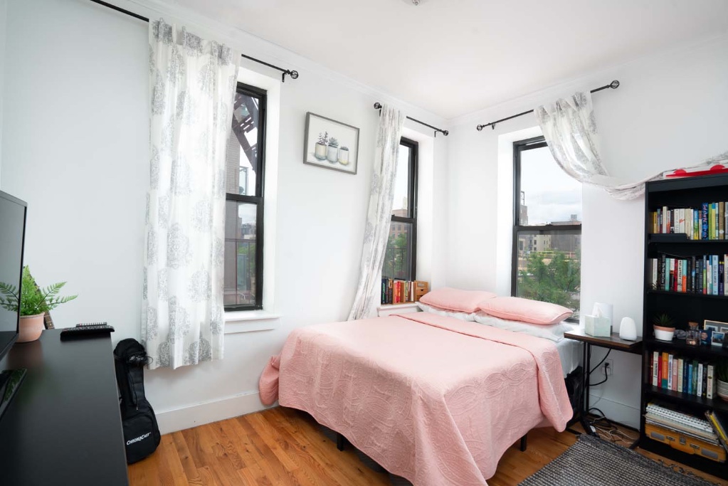 a bedroom with a bed furniture and a book shelf