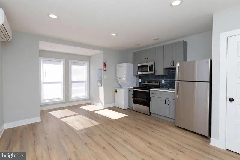 a kitchen with granite countertop a refrigerator stove top oven and sink