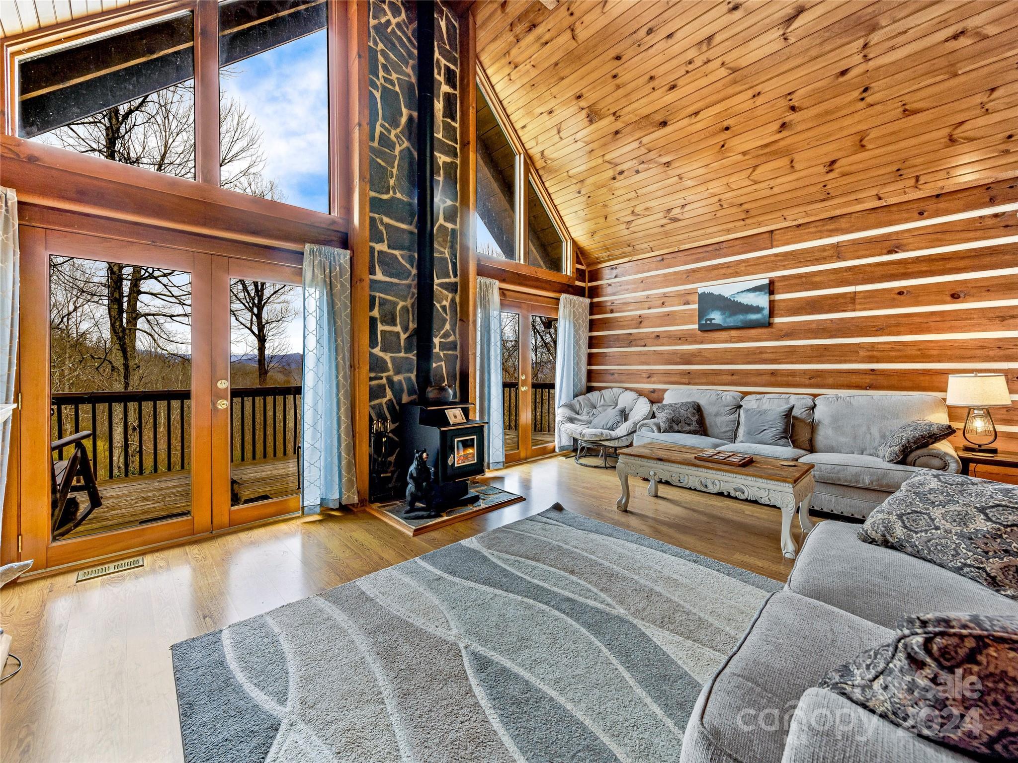 a bedroom with furniture and large windows