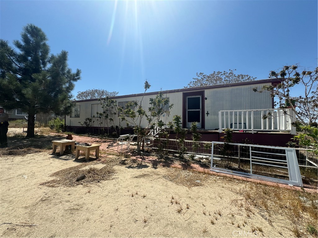 a view of house with yard outdoor seating and covered with snow