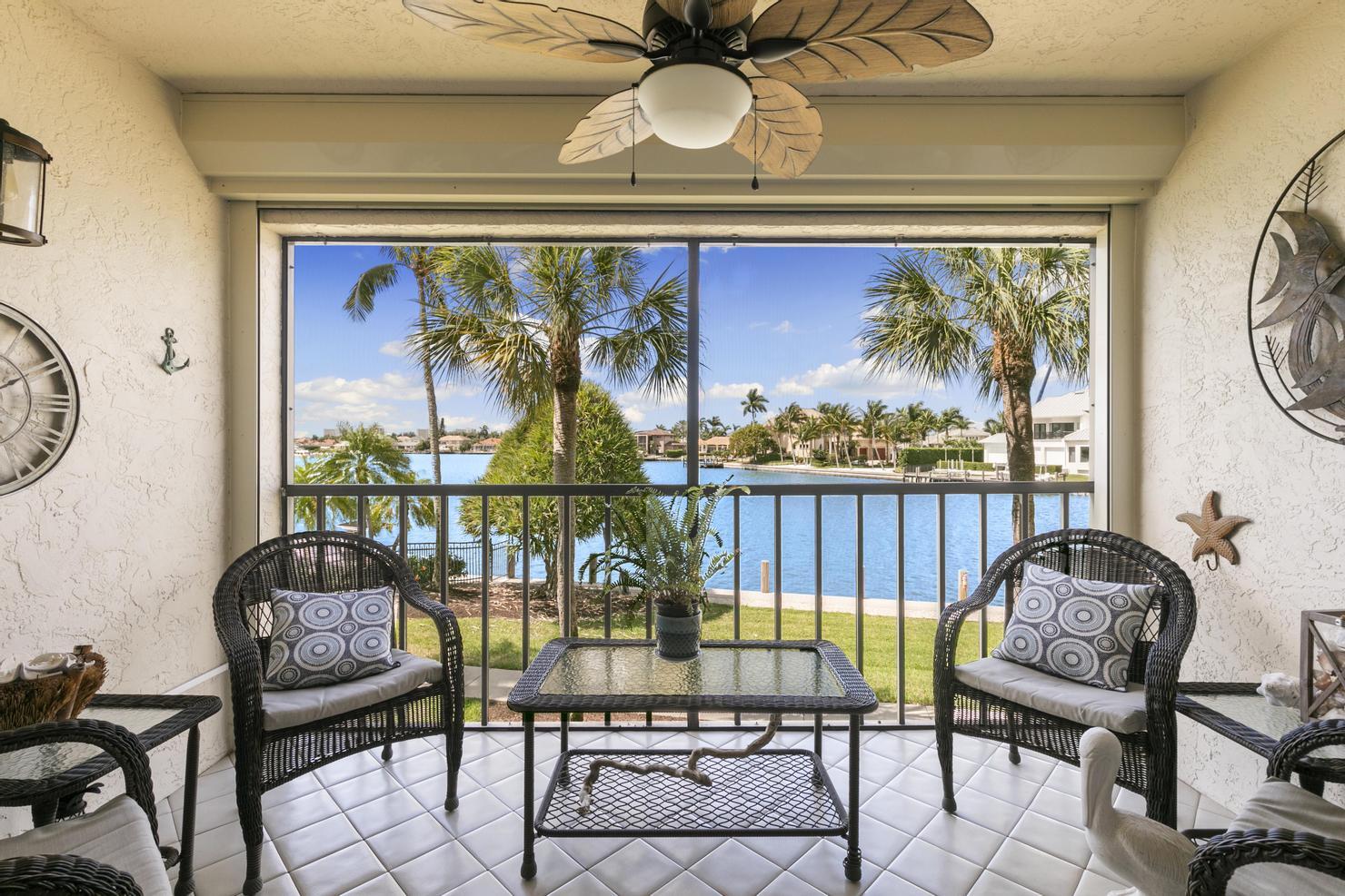 a balcony with furniture and a large window