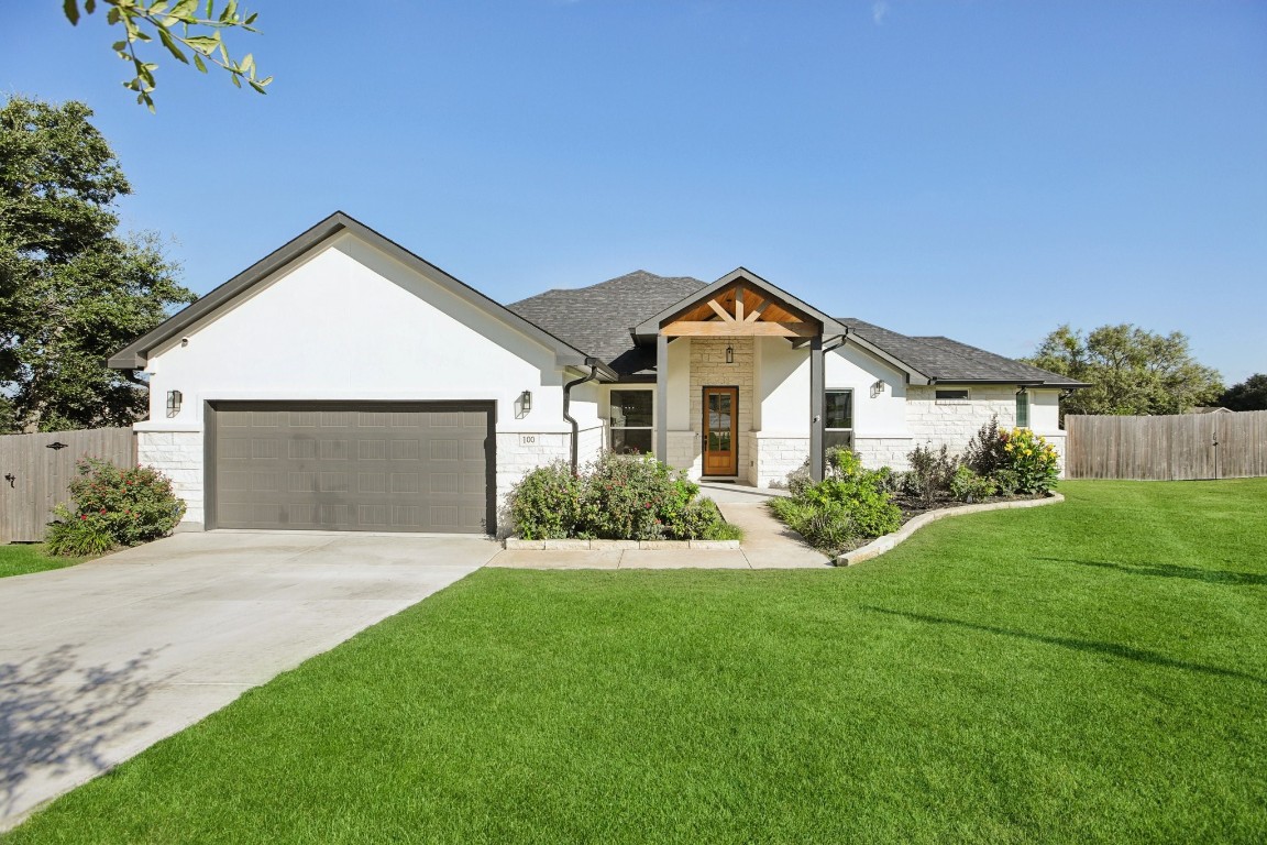 a front view of house with yard and green space