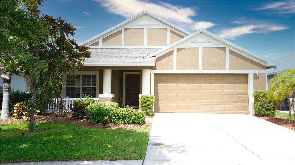 a front view of a house with a yard and garage