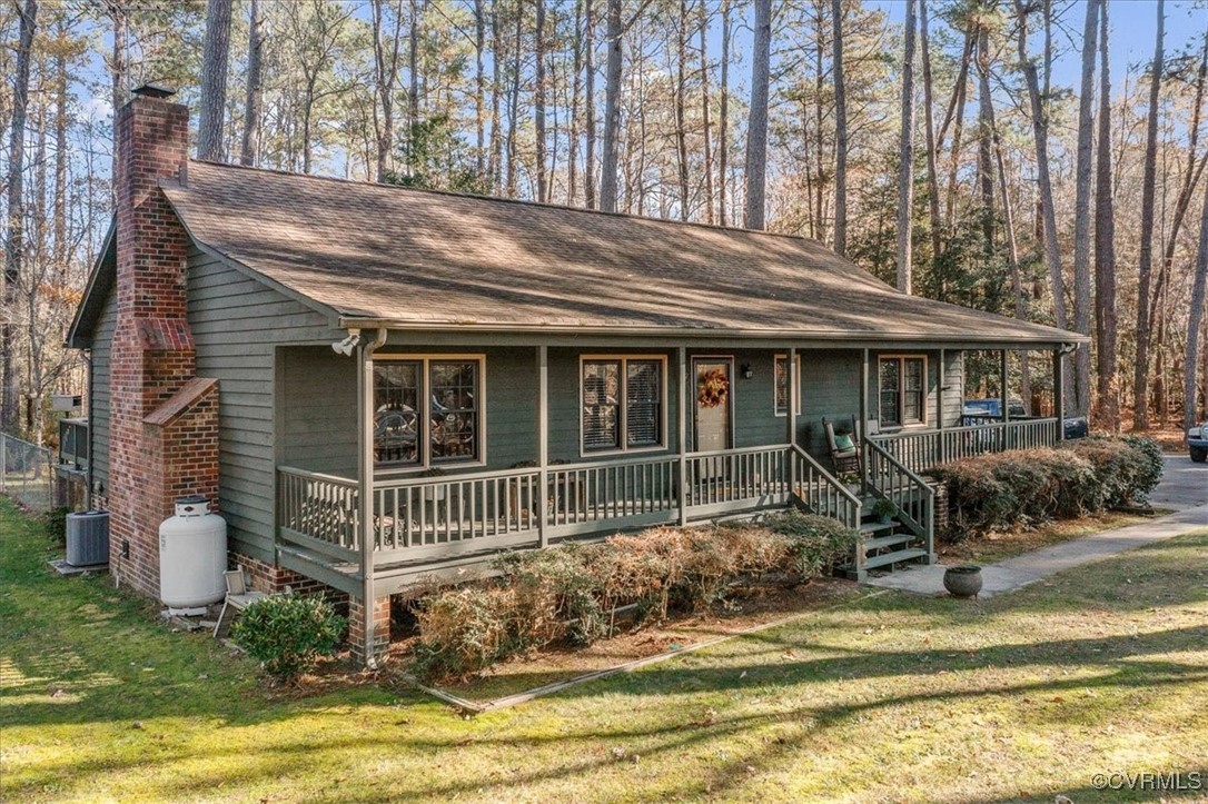 View of front of home featuring cooling unit, cove