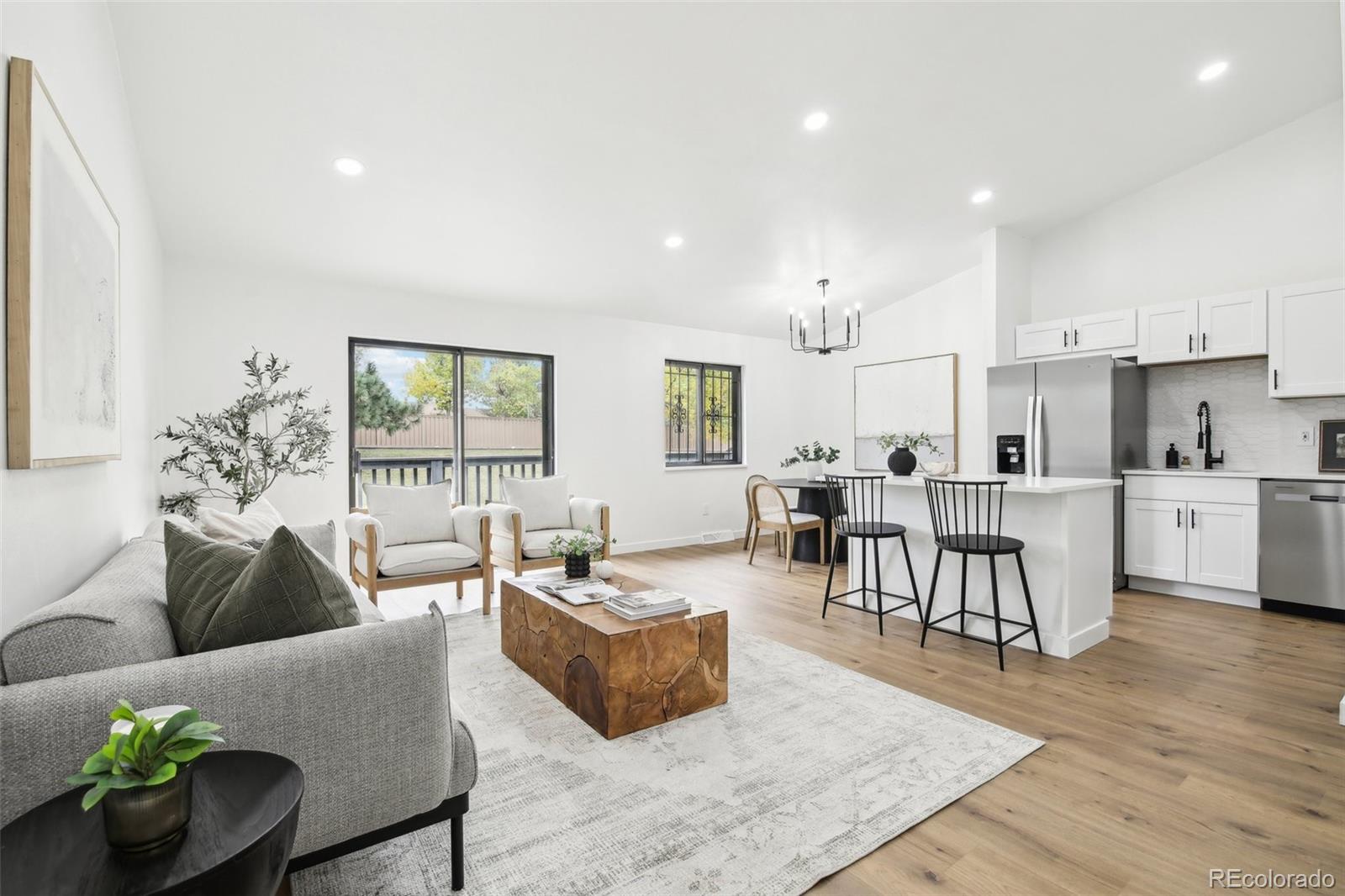 a living room with furniture wooden floor and a table