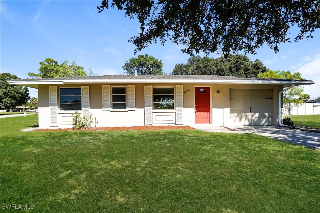 a front view of house with yard outdoor seating and green space