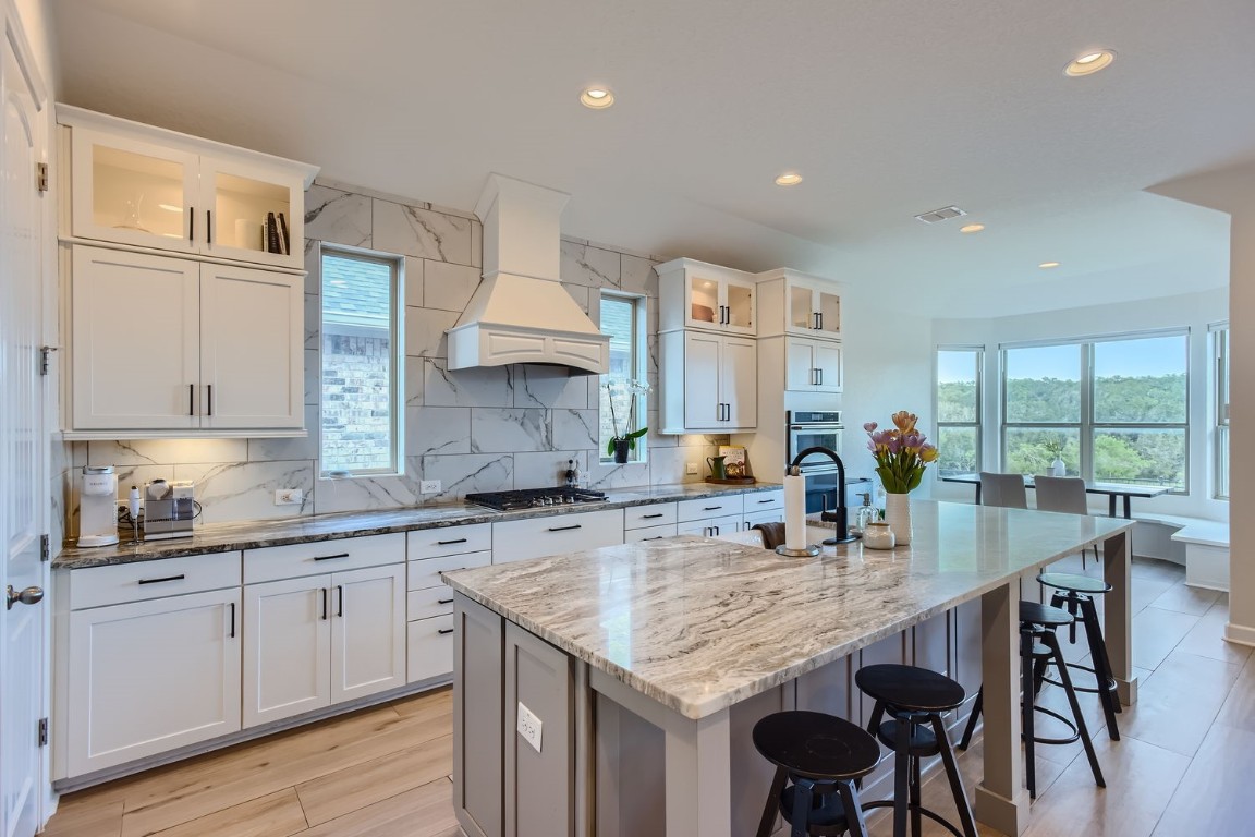 a kitchen with granite countertop a sink and cabinets