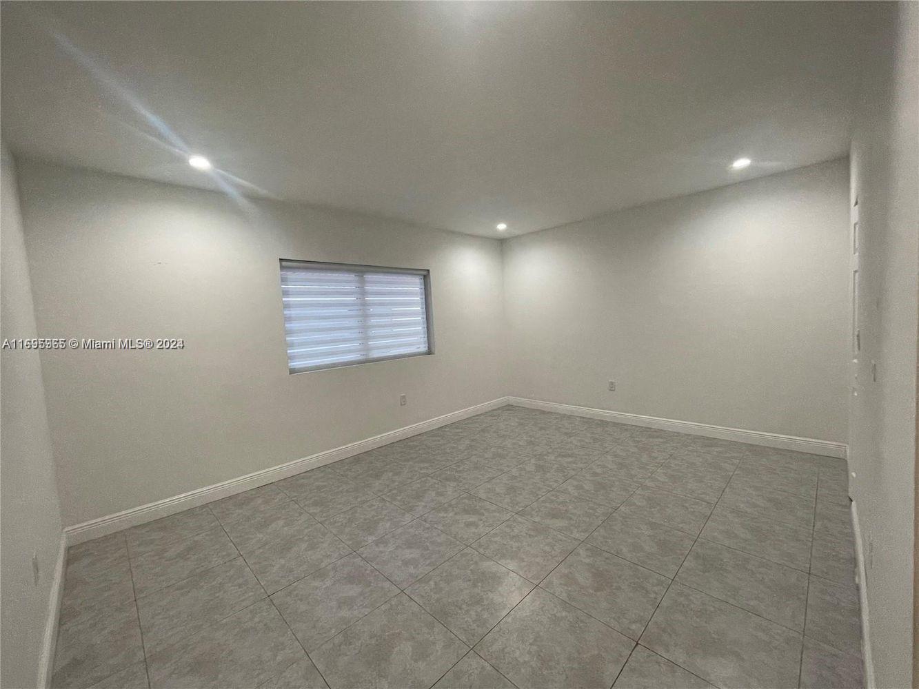 an empty room with a empty space and windows