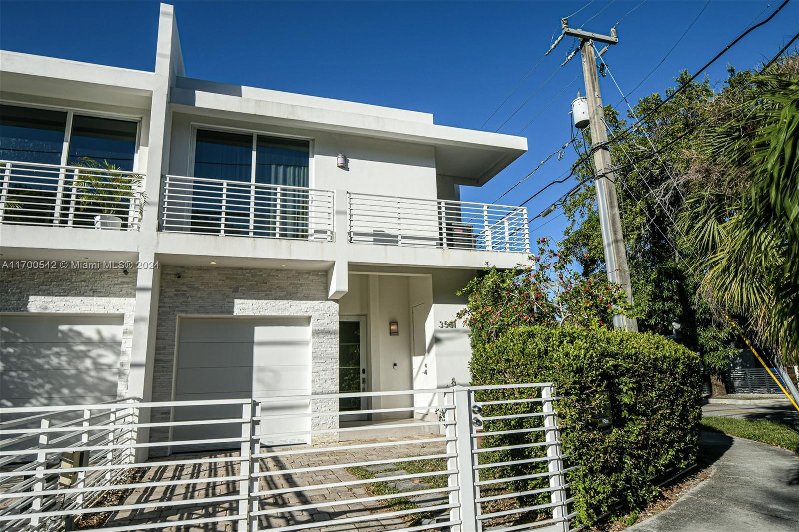 a front view of a house with plants