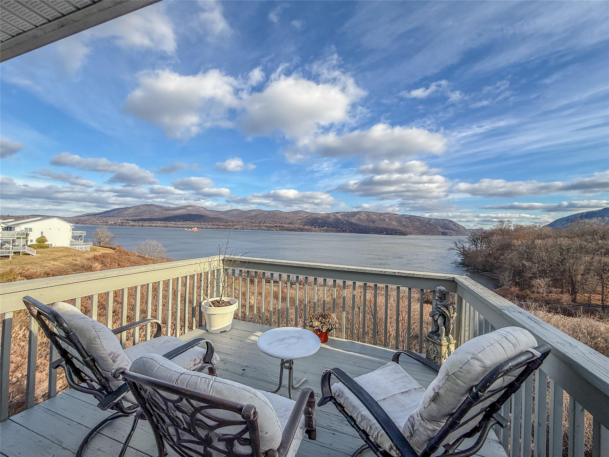 Wooden deck featuring a water and mountain view