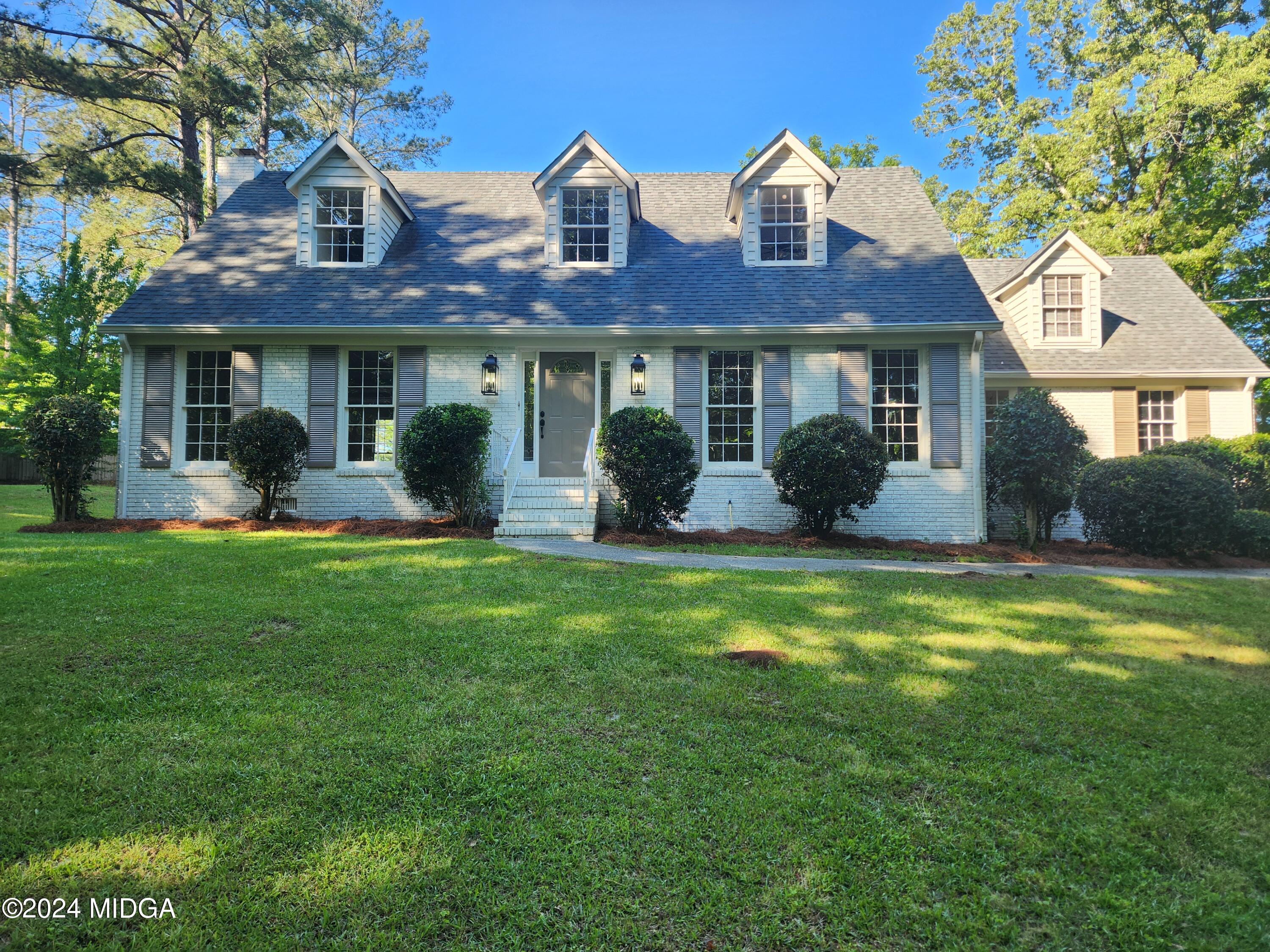 a front view of house with yard and green space