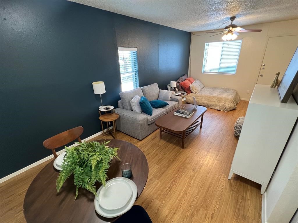 a living room with furniture and a wooden floor