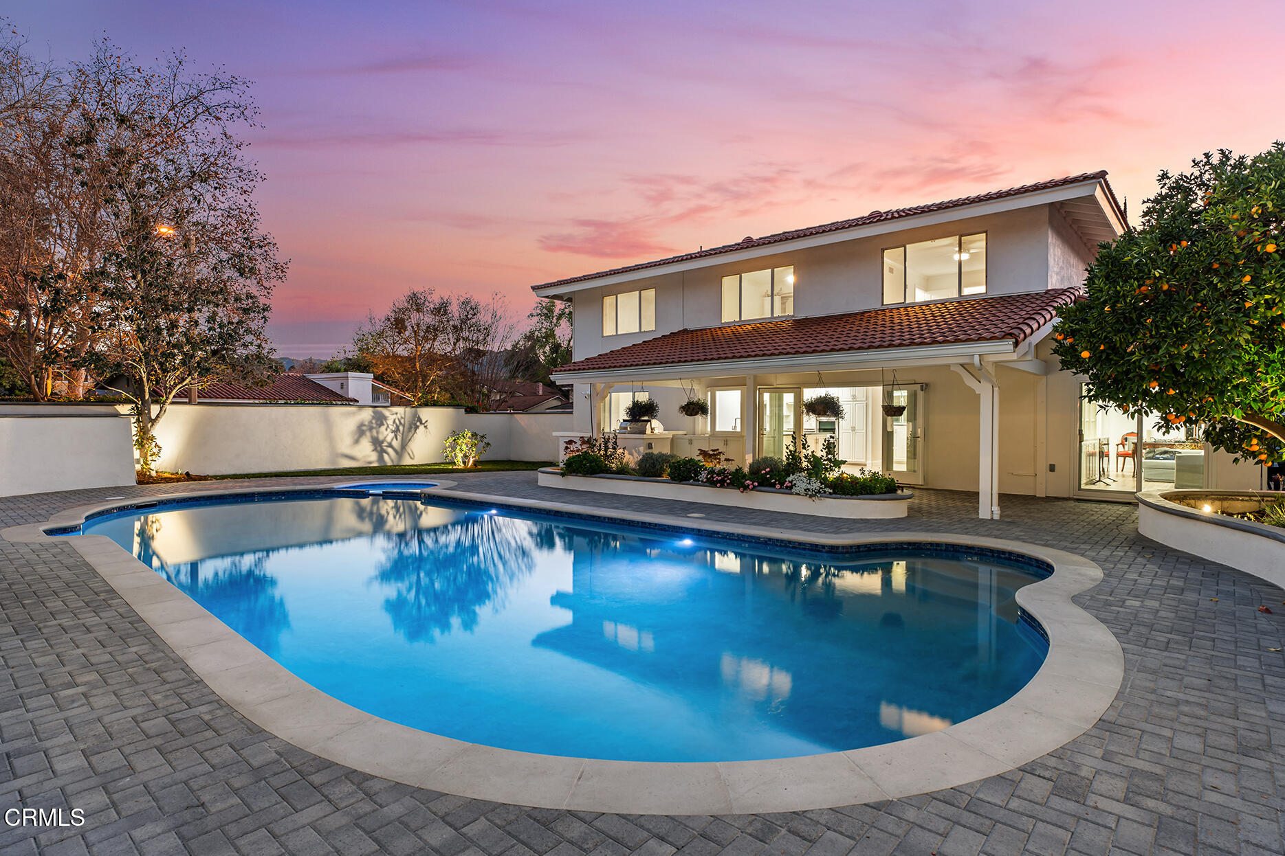 a view of a house with swimming pool and sitting area