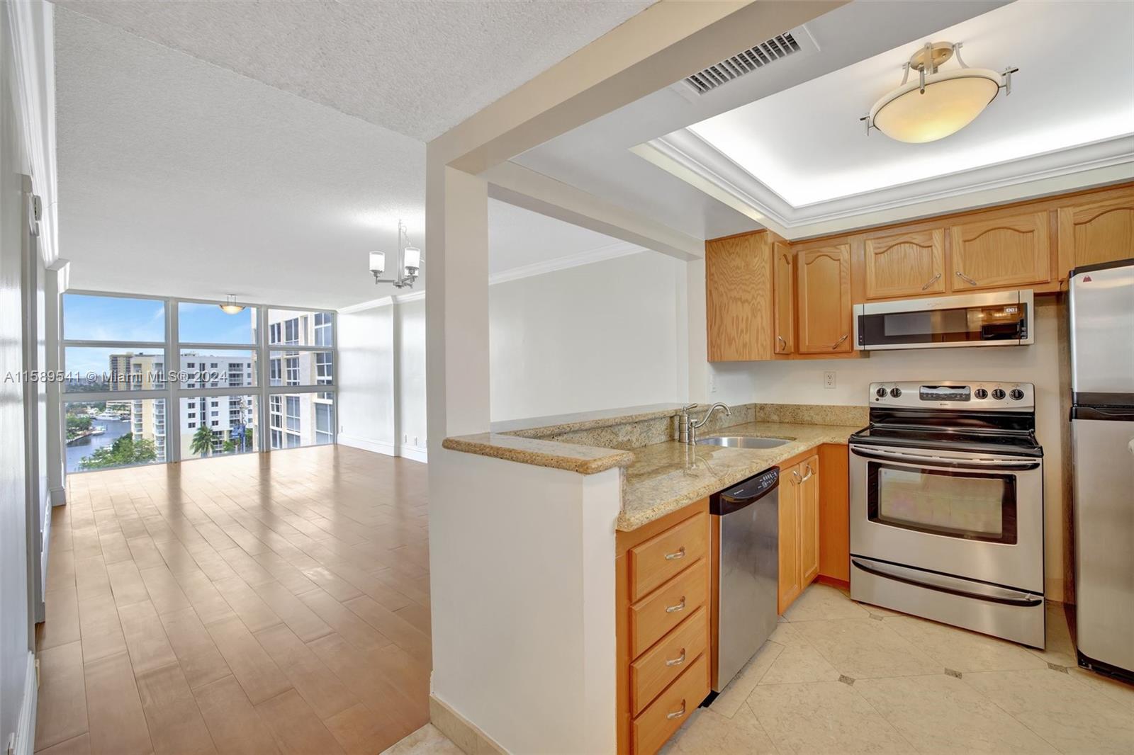 a kitchen with stainless steel appliances granite countertop a stove and a refrigerator