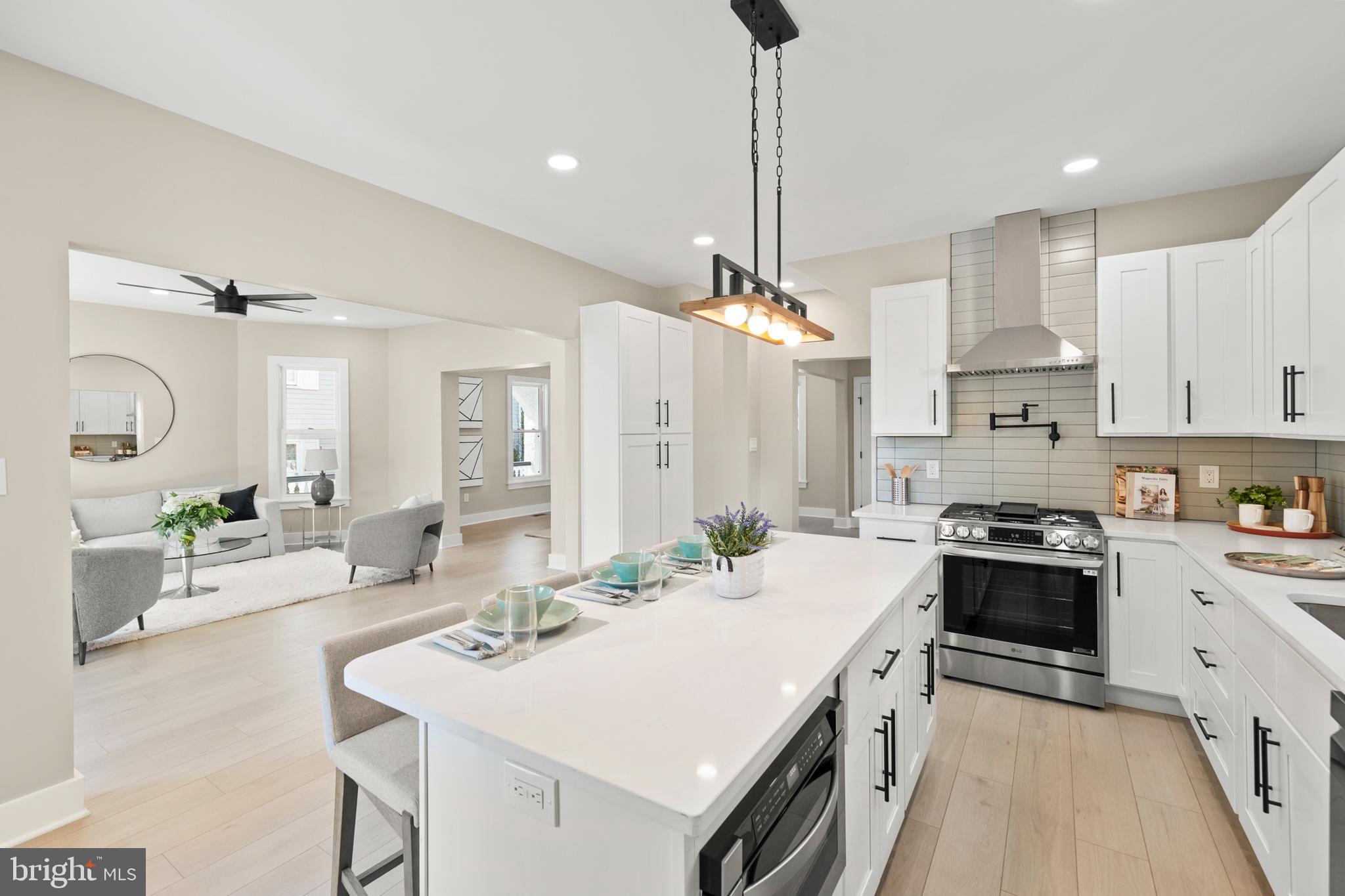 a kitchen with stainless steel appliances a sink stove and refrigerator