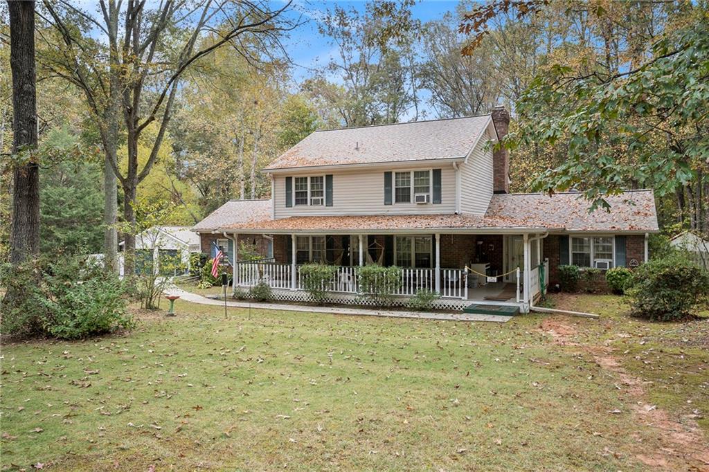 a front view of a house with a yard balcony and sitting area