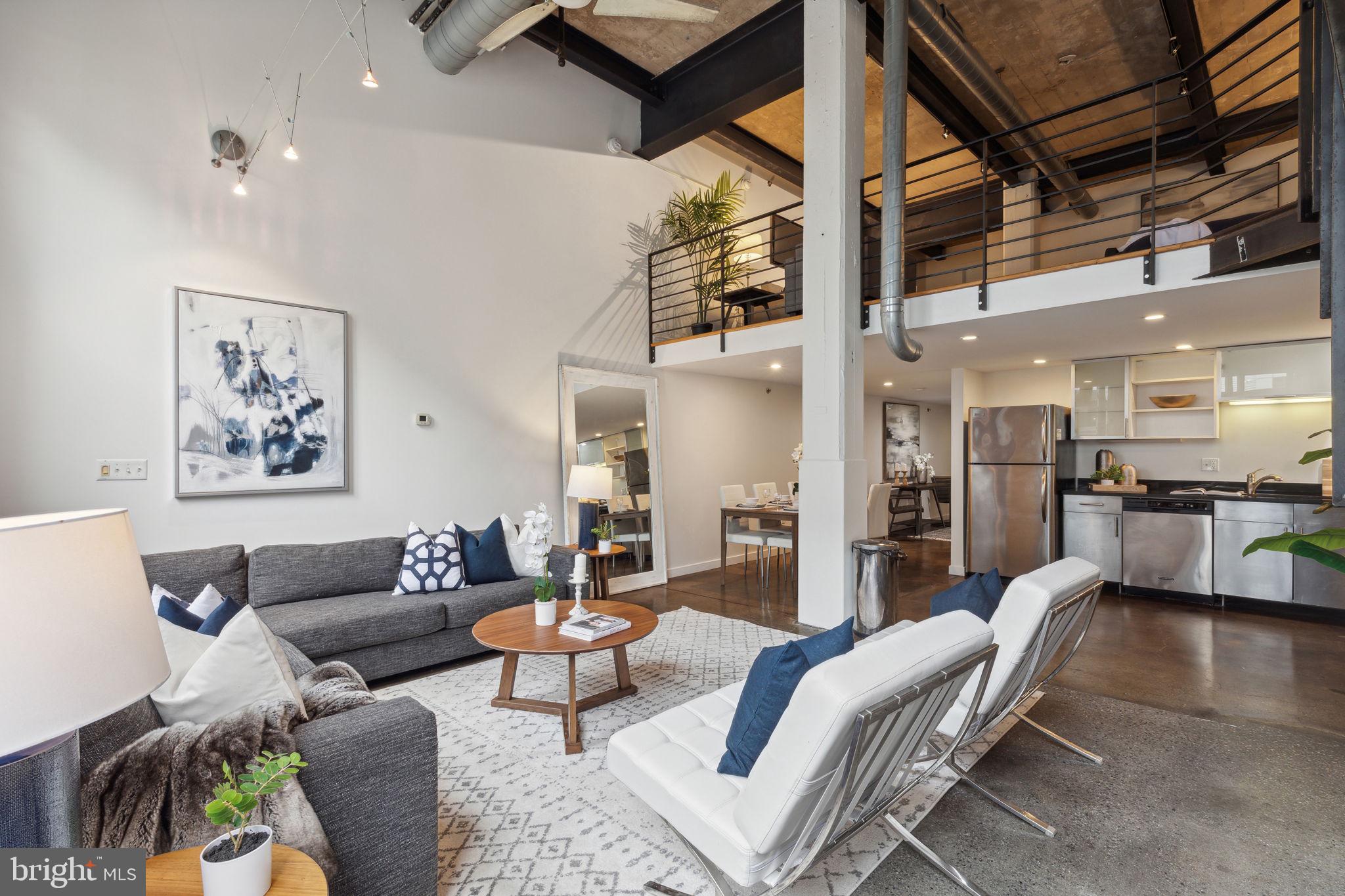 a living room with furniture and kitchen view