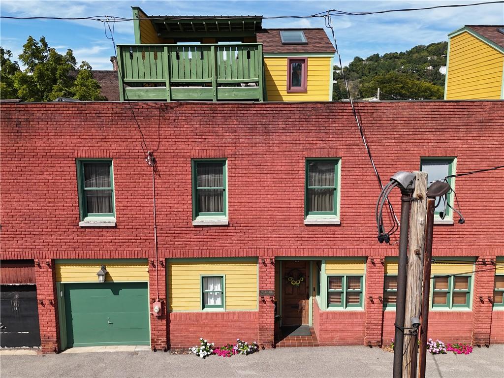 front view of a brick house with a small yard